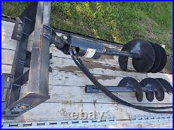 Skid steer post hole auger. Includes mount, hydraulic drive motor, 18and12 bits
